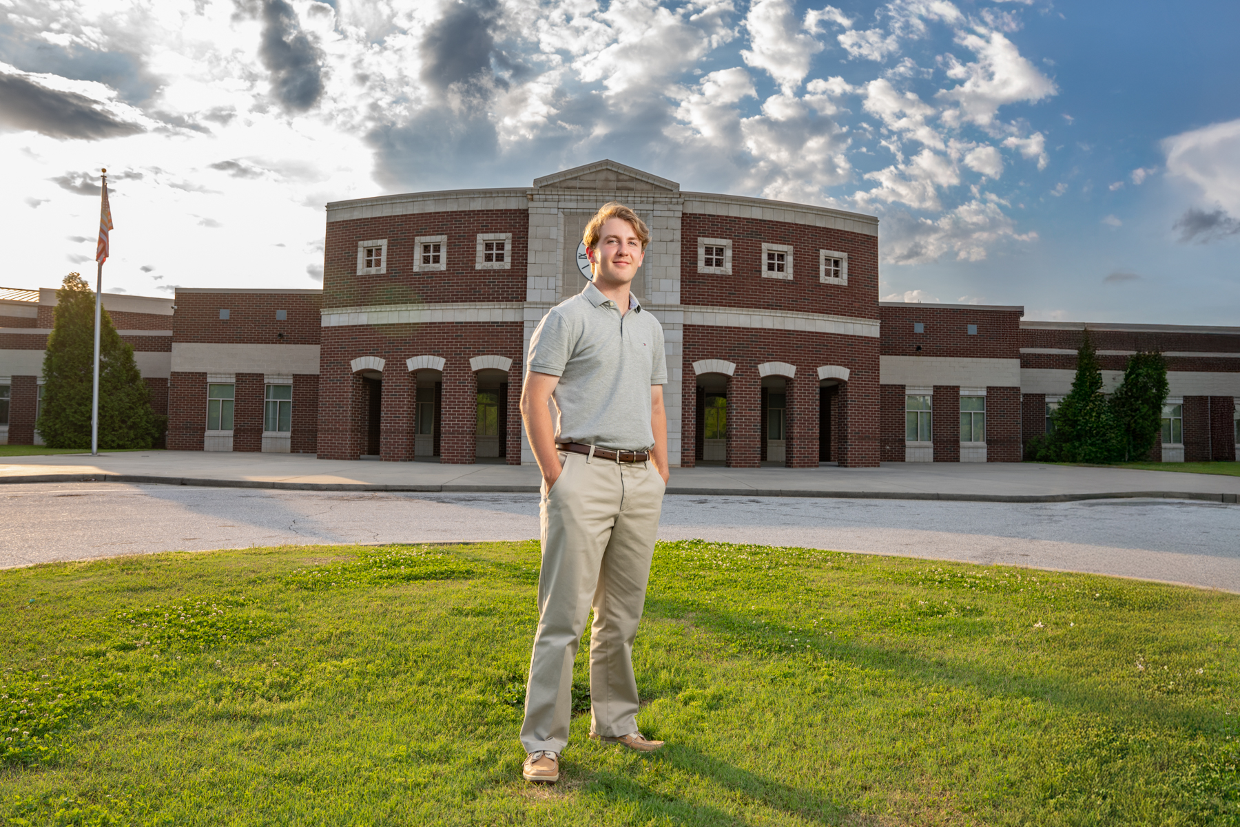 Dorman high school senior standing for pose in front of Dorman high school for senior pictures taken by Taylor johnson photography.