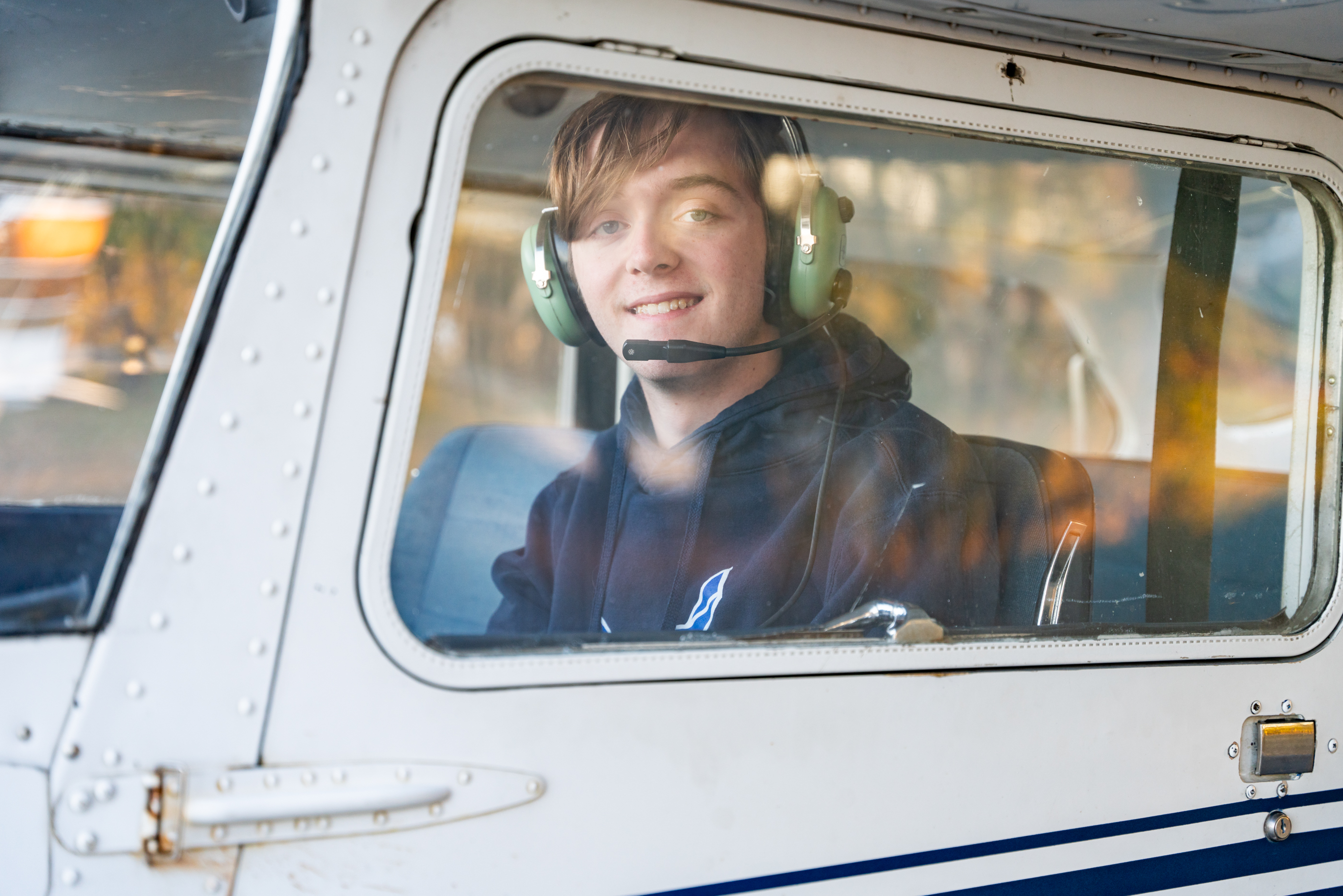 high school senior posing in a plane for session