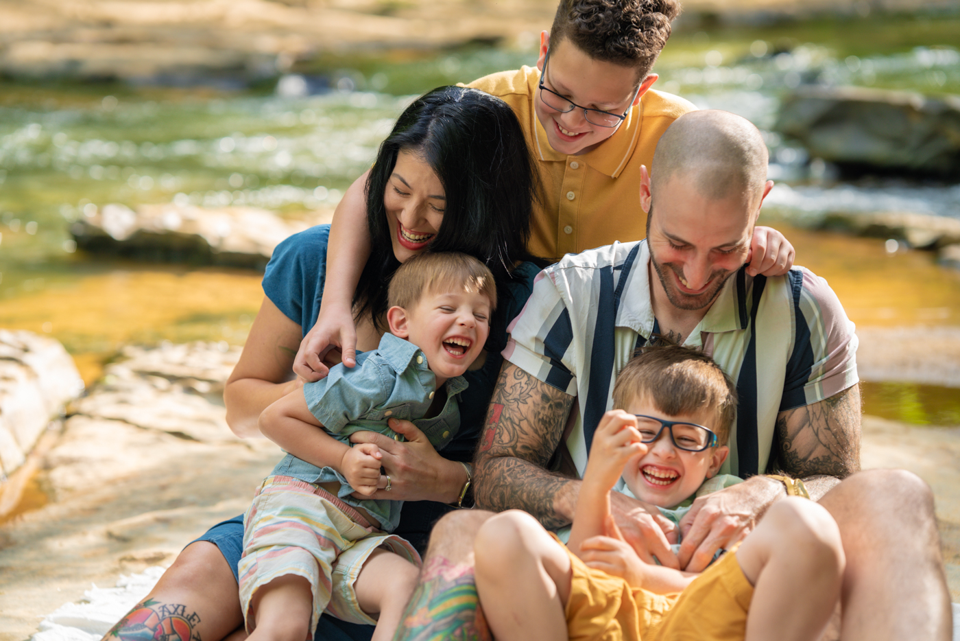 family poses for a photo at conestee nature preserve in Simpsonville, South Carolina taken by photographer Taylor Johnson for the Simpsonville Neighbors magazine published by Rachael Wiles