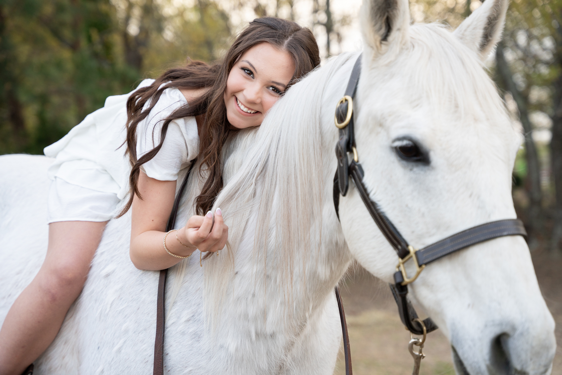 Byrnes high school senior girl poses on top of a horse for high school senior photos taken by Taylor Johnson photography in Fountain Inn, SC