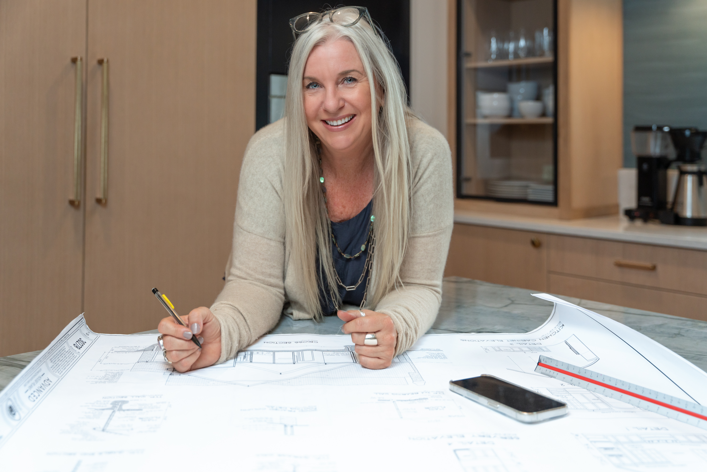 interior designer posing in a kitchen with design materials for branding shoot with upstate South Carolina photographer Taylor Johnson 